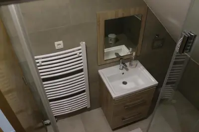 a small bathroom with a sink and a mirror at Apartmani Vlašić-Petrol in Travnik