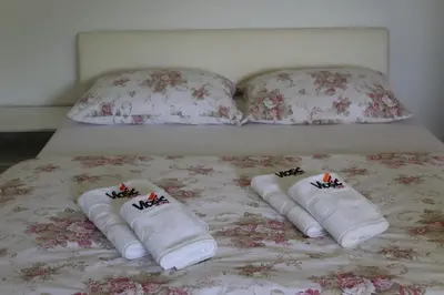 a bed with three towels on it with two pillows at Apartmani Vlašić-Petrol in Travnik
