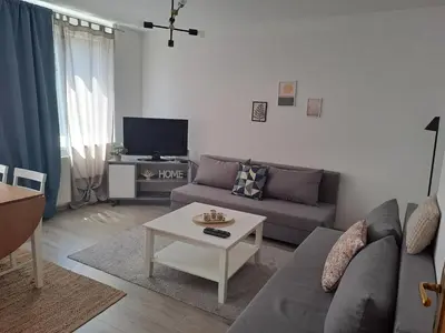 a living room with a couch and a table at Enjoy traveling in Tuzla