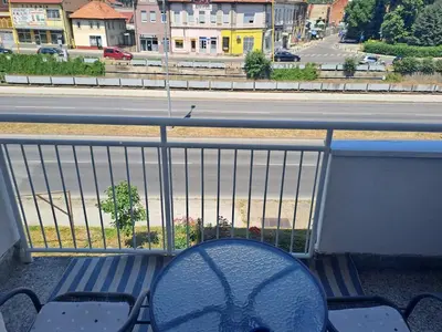 a bench on a balcony with a view of a street at Enjoy traveling in Tuzla
