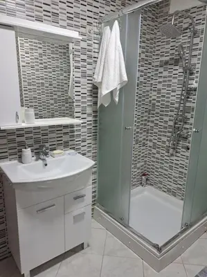 a bathroom with a shower and a sink and a tub at Enjoy traveling in Tuzla