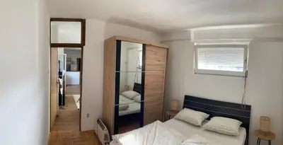 a bedroom with a bed and a large mirror at Penthouse stan 80m2, terasa 36m2, garaža... centar Banja Luke - gradski park in Banja Luka