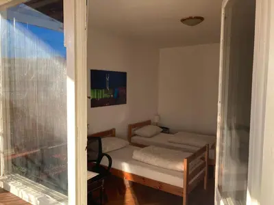 a small room with a bed and a window at Penthouse stan 80m2, terasa 36m2, garaža... centar Banja Luke - gradski park in Banja Luka