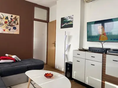 a living room with a couch and a flat screen tv at Penthouse stan 80m2, terasa 36m2, garaža... centar Banja Luke - gradski park in Banja Luka
