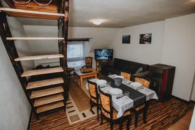 a living room with a table and a bunk bed at Apartments Kiki Vlašić in Vlasic