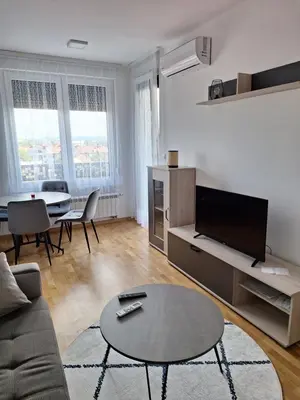 a living room with a couch and a table at Apartman Mia 2 Banja Luka in Banja Luka
