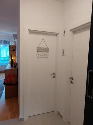 a white door with a sign on it at Apartman Mia Banjaluka in Banja Luka
