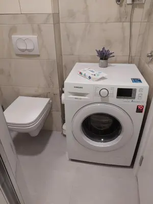 a washing machine in a bathroom with a toilet at Apartman Mia Banjaluka in Banja Luka