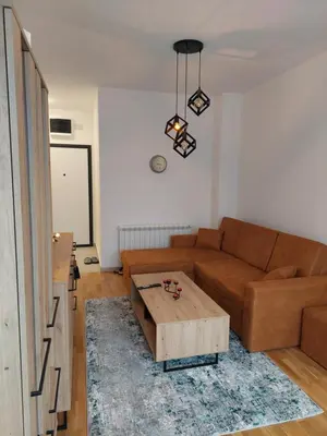 a living room with a couch and a coffee table at Apartman Mia Banjaluka in Banja Luka