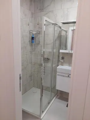 a shower with a glass door in a bathroom at Apartman Mia Banjaluka in Banja Luka