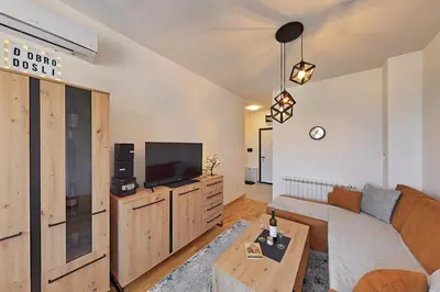 a living room with a couch and a tv at Apartman Mia Banjaluka in Banja Luka