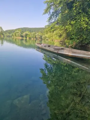 a body of water with a dock and trees at Eurouna relax in Bosanska Krupa