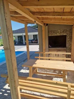 a wooden pergola with a table and a television at Eurouna relax in Bosanska Krupa