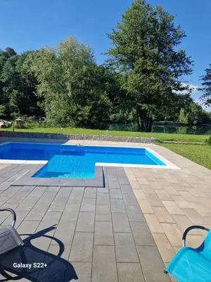 a swimming pool in a yard with a patio and trees at Eurouna relax in Bosanska Krupa