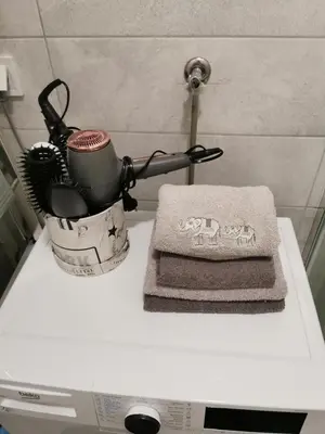 a counter top with a cup and towels on it at Alex LUX in Banja Luka
