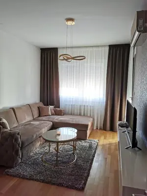 a living room with a couch and a table at Alex LUX in Banja Luka
