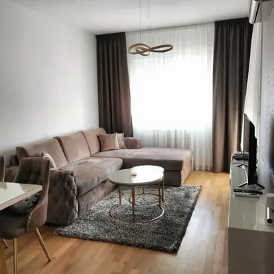 a living room with a couch and a table at Alex LUX in Banja Luka