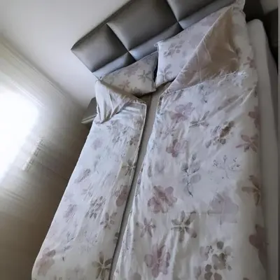 a bedroom with a bed with pink flowers on it at Alex LUX in Banja Luka
