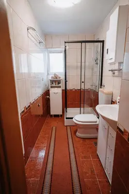 a bathroom with a shower and a toilet and a sink at CosyHouse-Kupres in Kupres