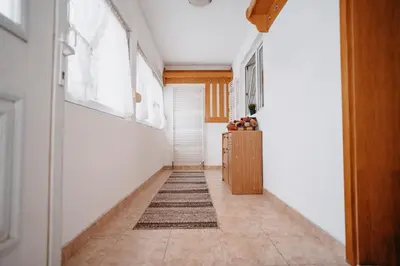 a hallway with white walls and a rug on the floor at CosyHouse-Kupres in Kupres