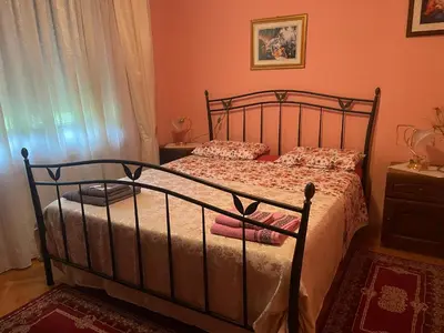 a bedroom with a bed with a metal frame at Villa Janković in Modriča