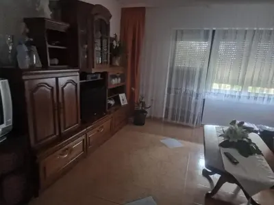 a living room with a tv and a couch and a table at Villa Janković in Modriča