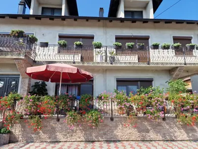 a brick building with flower boxes and an umbrella at Villa Janković in Modriča