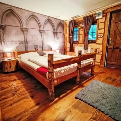 a bedroom with a large bed and a wooden floor at Kraljevsko selo Kotromanićevo in Doboj