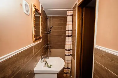 a small bathroom with a toilet and a sink at Kraljevsko selo Kotromanićevo in Doboj