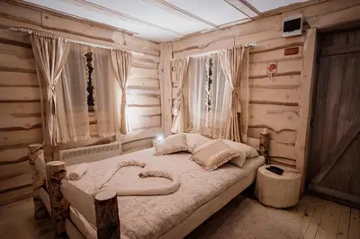 a bedroom with a bed in a wooden room at Kraljevsko selo Kotromanićevo in Doboj
