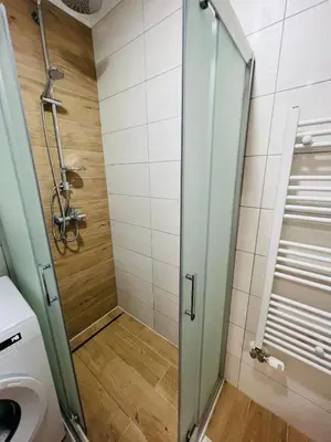 a bathroom with a shower and a toilet at GRAND LUX Mihajlo in Doboj