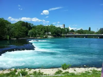 a river with blue water and a bridge in the background at Watermill 102 - Apartment Krupana in Bosanska Krupa