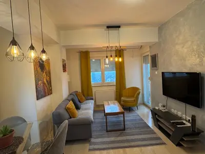 a living room with a couch and a tv at Apartman Vera in Banja Luka