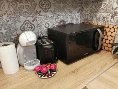 a microwave oven sitting on top of a kitchen floor at Apartman Vera in Banja Luka