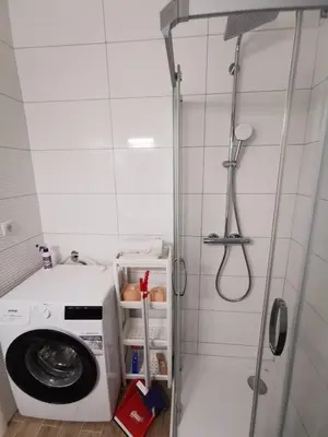 a washing machine in a bathroom with a shower at Apartman Vera in Banja Luka