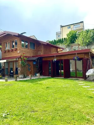 a house with a lawn in front of it at Apartmani Lara&Sara in Bihać