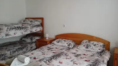 a bedroom with a bed and two bunk beds at Apartman Melani in Kupres