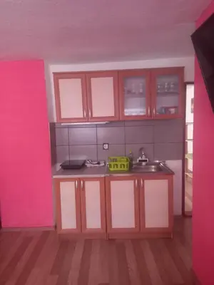 a kitchen with brown cabinets and a sink at Apartman Melani in Kupres