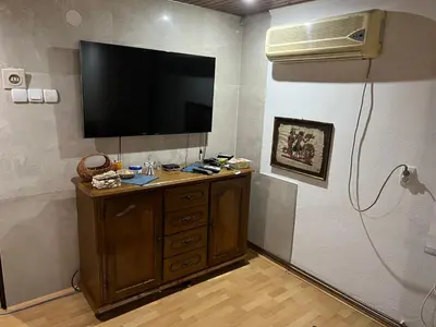 a room with a television on a wall with a dresser at Apartman SI in Banja Luka