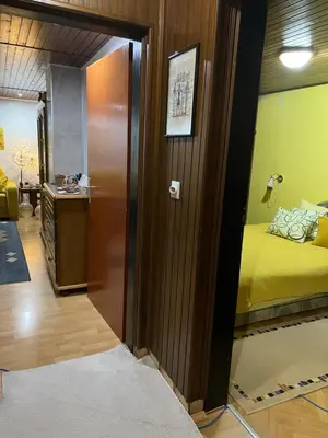 a room with a door leading to a room with a bed at Apartman SI in Banja Luka