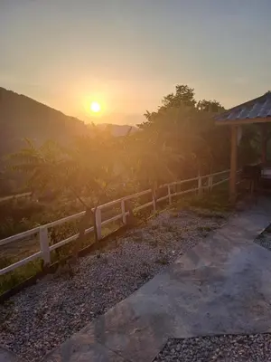 a fence with the sunset in the background at Natural House in Visoko