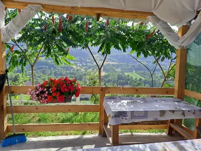 a bed in a gazebo with flowers on it at Natural House in Visoko