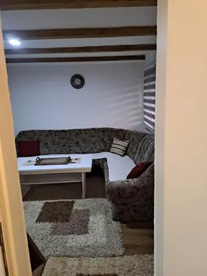 a living room with a couch and a table at Natural House in Visoko