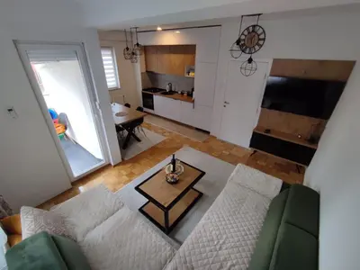 a living room with a couch and a table at Golemovic Comfort Stay in Banja Luka