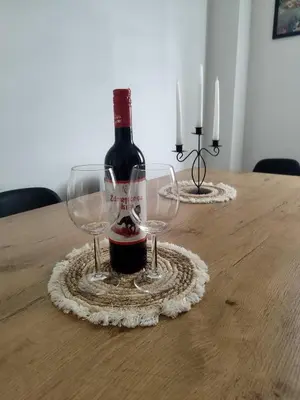 a bottle of wine and two wine glasses on a table at Golemovic Comfort Stay in Banja Luka
