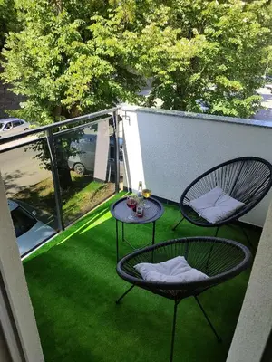 a patio with two chairs and a table on a balcony at Golemovic Comfort Stay in Banja Luka