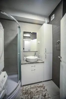 a small bathroom with a sink and a shower at Golemovic Comfort Stay in Banja Luka