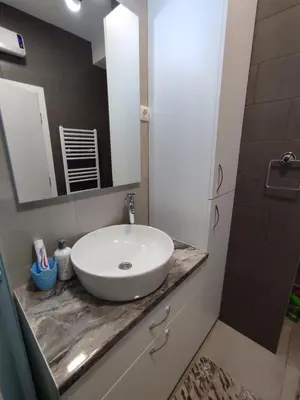 a bathroom with a white sink and a mirror at Golemovic Comfort Stay in Banja Luka