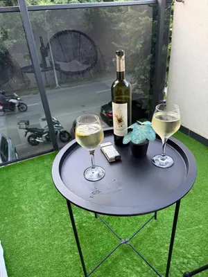 a table with two wine glasses and a bottle of wine at Golemovic Comfort Stay in Banja Luka