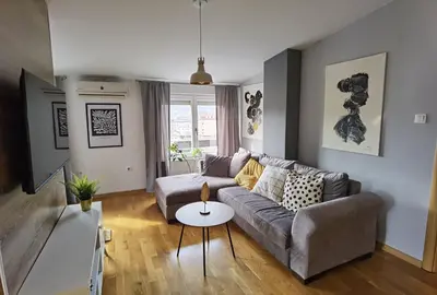a living room with a couch and a table at Prestige Banja Luka in Banja Luka